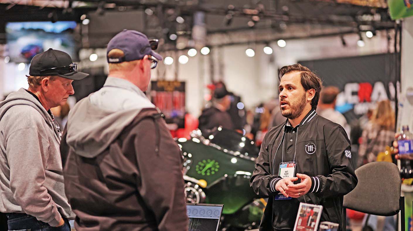 Men discussing product at a show booth