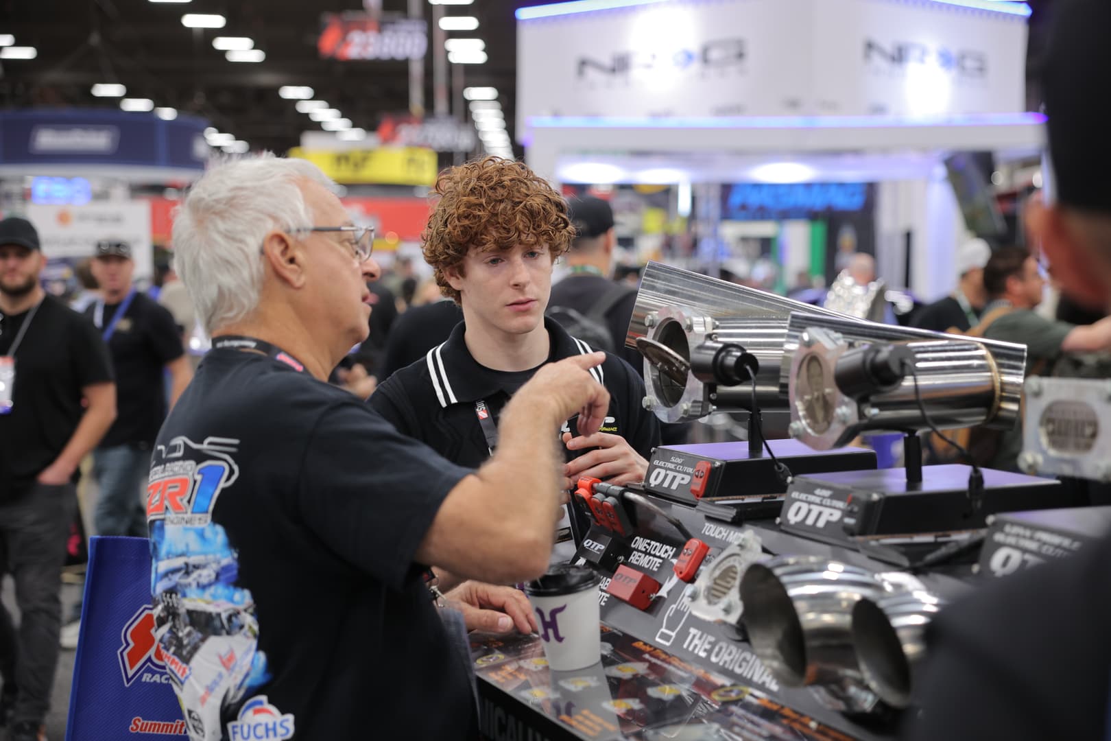 Exhibitors discussing precision-machined performance components