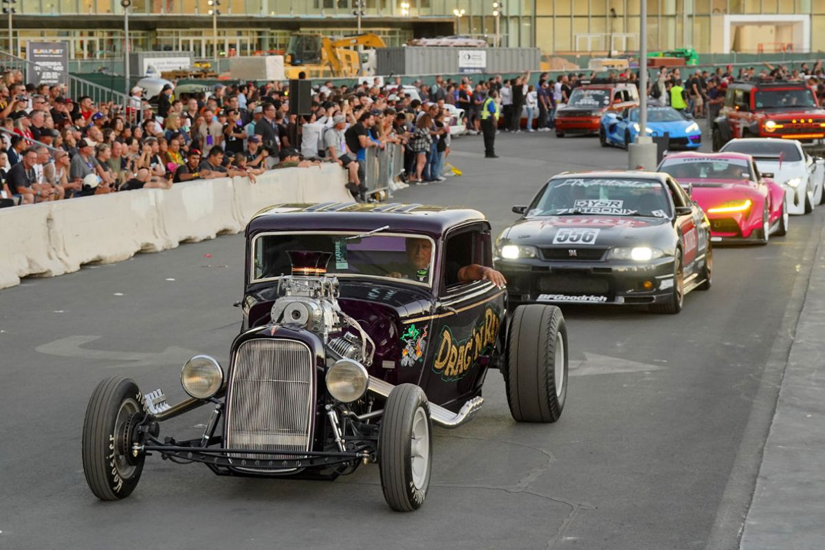 Parade of cars exiting the Las Vegas Convention Center after the SEMA Show close.