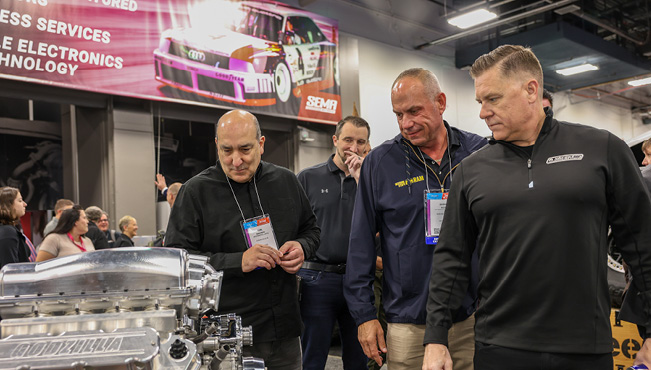 People_examining_car_engine_parts