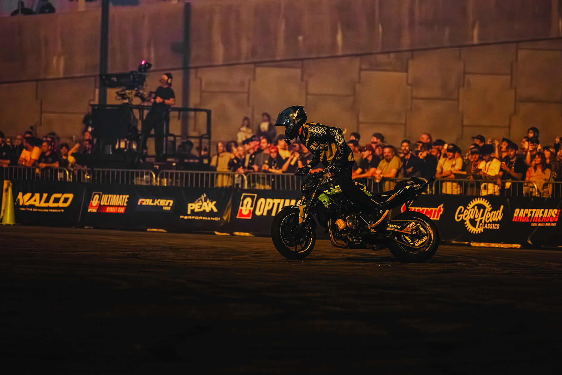 Motorcyclist performing in  front of a crowd
