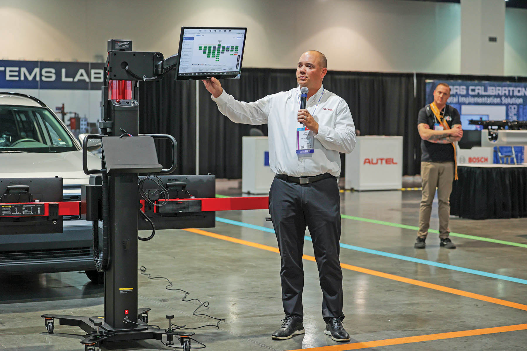 Man presenting at the Future Tech booth at the SEMA Show