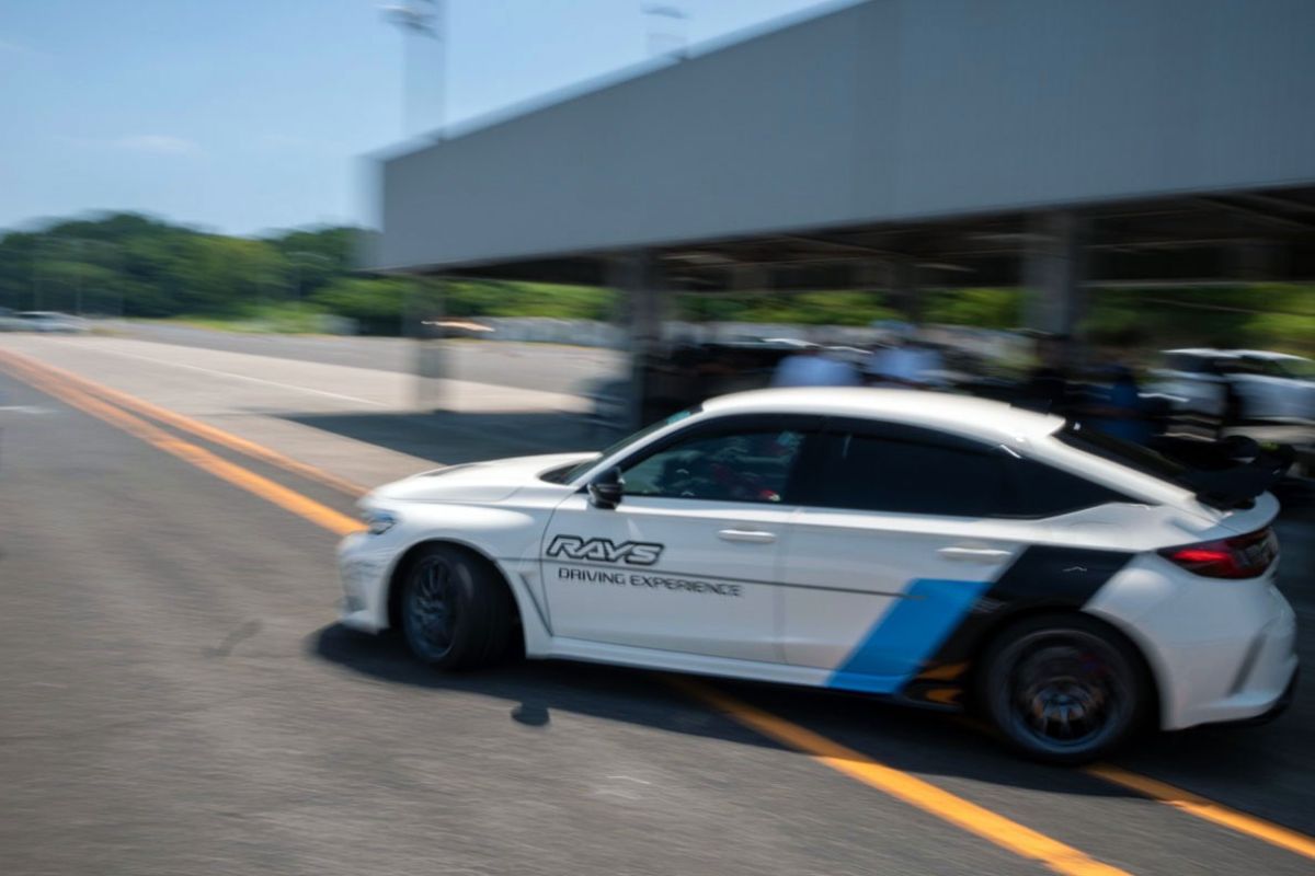 Car with Rays logo in motion. Motion blurred background to motion effect.