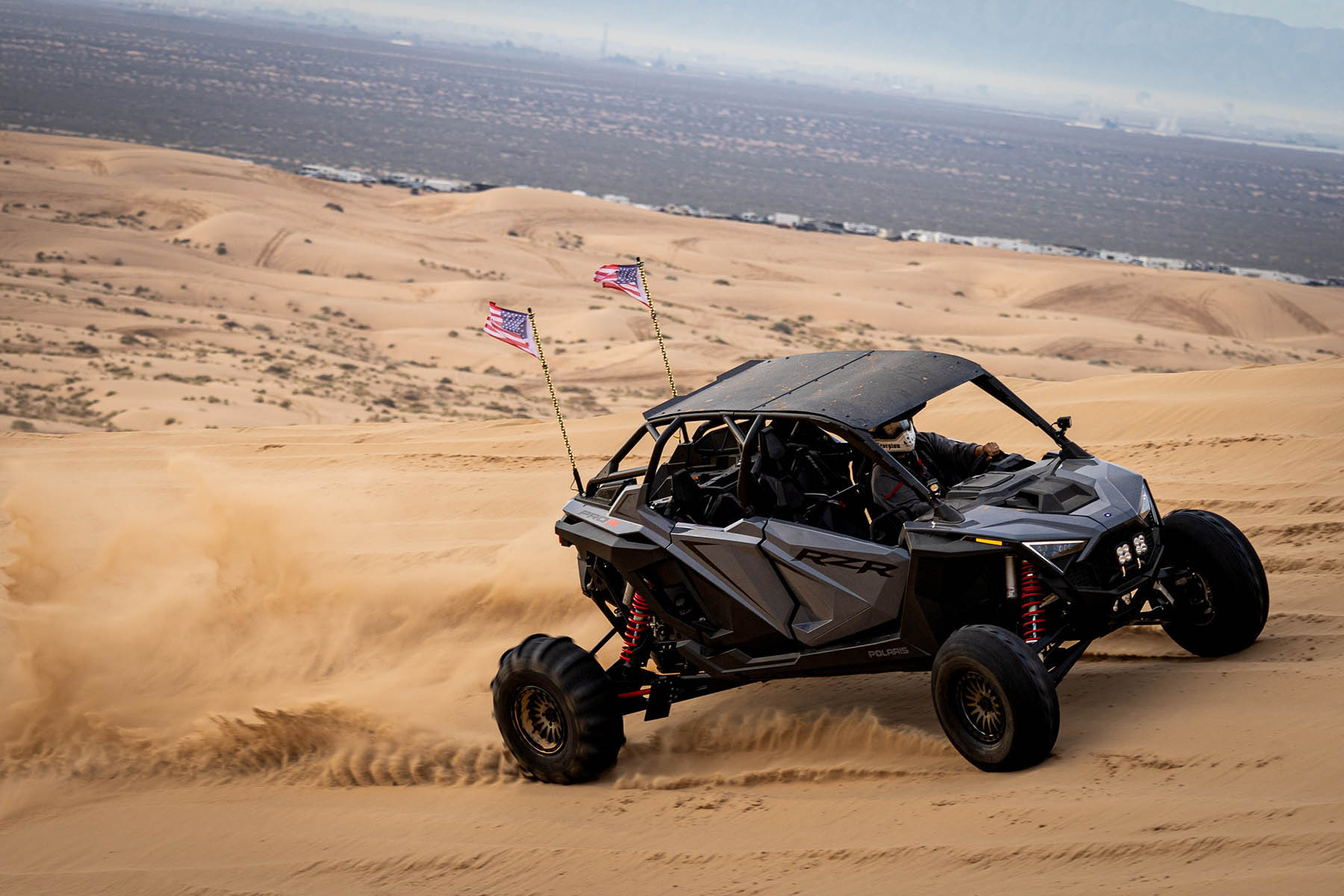 SxS in the desert climbing a dune.